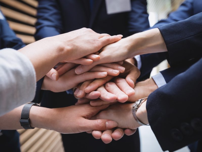close-up of hands stack of business people